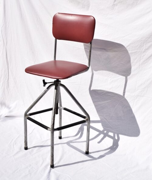 A TALL ENGLISH OPERATORS STOOL FROM THE 1940S/50S